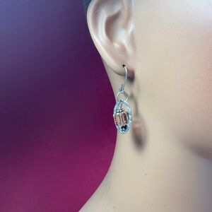 Sterling Silver dangle earrings with a pinkish color bead. 1.5 inches long